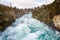 Huka Falls on the Waikata River, Wairakei National Park, New Zealand. Raging torrent flows through rocky, tree lined gorge