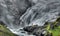 A Huldra seductive forest creature dances in front of the Kjosfossen waterfalls near to flam, Norway