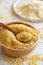 Hulled millet grain and flour in bowls