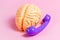 Human brain using dial phone on light pink background. Phone addiction, support service call, social problems concepts.