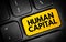 Human Capital - economic value of a worker\\\'s experience and skills, text button on keyboard