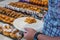 Human choosing pastry croissant at breakfast buffet counter