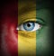Human face painted with flag of Guinea