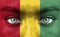 Human face painted with flag of Guinea