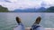 Human Feet on the Background of a Mountain Lake and Snow-covered Mountains.