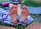 human feet after standing on yoga nail desk sadhu closeup photo on green grass background