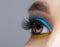 Human female eye with blue smoky eyes shadows and yellow liner