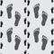 Human footprints gray seamless pattern