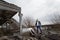 Human in gas mask standing among ruins and dramatic sky background. Enviromental pollution, ecology disaster, radiation