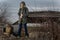 Human in gas mask standing among ruins and dramatic sky background. Enviromental pollution, ecology disaster, radiation, biologica