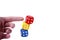 Human hand / finger pushing a tower like structure made of colorful game dices. Simple concept of no stability, demolition