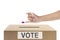 Human hand gesture after inserting vote paper into ballot box