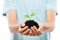 Human hand holding green sprout leaf growth at dirt soil