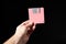 Human hand holding pink floppy disk