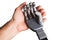 Human hand holding robotic hand
