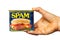 Human hand holding a tin can of SPAM canned meat