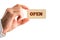 Human Hand Holding Wooden Piece with Open Text