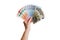A human hand holds euro banknotes