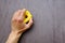 human hand holds on yellow climbing hold on artificial climbing wall, concept of sport education, copy space