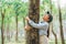 Human hand Hug and touching tree in the forest .people protect from deforestation and pollution or climate change Concept to love