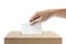 Human hand inserts vote paper into ballot box