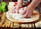 Human hand knead pizza dough