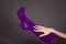 Human hand with manicure touch purple boot