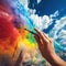 Human hand painting clouds in rainbow colors with drawing brush on blue sky background. loudy sky background on sunny