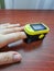 Human hand with a pulse oximeter on the index finger on a wooden background