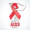 Human hand with red aids ribbon for World Aids Day concept.