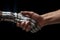 human hand shaking the hand of a robot