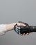 the human hand and the siber hand bionic prosthesis make a handshake and greeting. modern technologies of prosthetics