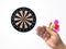 Human hand is throwing the darts target to the darts board. a man`s hand throws a dart at the target