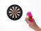 Human hand is throwing the darts target to the darts board. a man`s hand throws a dart at the target