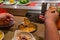 Human hand using chopsticks while having enoki mushroom hotpot