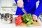 Human hands cooking vegetables salad