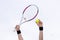 Human hands holding tennis ball and a racket on background of th