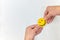 Human hands holding a yellow smiling face on a white background. Be happy and spread happiness concepts