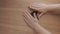 Human hands pile up black beans on wooden table