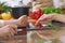 Human hands of two female persons using touchpad in the kitchen. Closeup of two women are making online shopping by