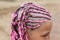 Human head with pink dreadlocks hairstyle, young Caucasian girl, close-up view