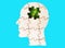 Human head puzzle with a plant piece on blue