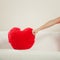 Human hitting heart shape pillow. Valentines day