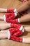 Human legs crossing on the floor with colorful Cristmas socks with red and white ornament