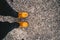 Human legs in dark pants yellow boots on  pavement