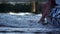 Human legs in foaming water flow. Love couple boating on river in evening.