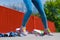 Human legs skater with skateboard on street.