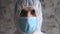 Human man doctor in protective clothes during coronavirus pandemic, portrait. Part of face in suit, mask. Protection