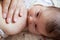 Human milk feeding with female breast, newborn baby breastfeeding, face