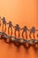 Human paper figures in front of metal chain on a red surface. Freedom, human rights, independence.